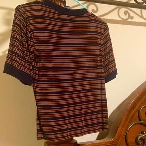 blue and orange stripped crop fits realllyyy well and gives 80’s vibes